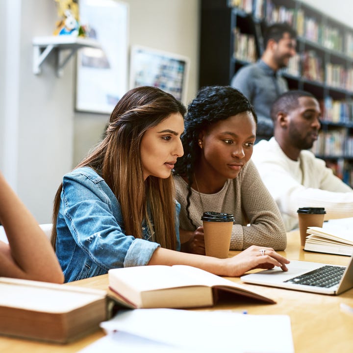 Students_Looking_at_Computer_in_Group.jpg